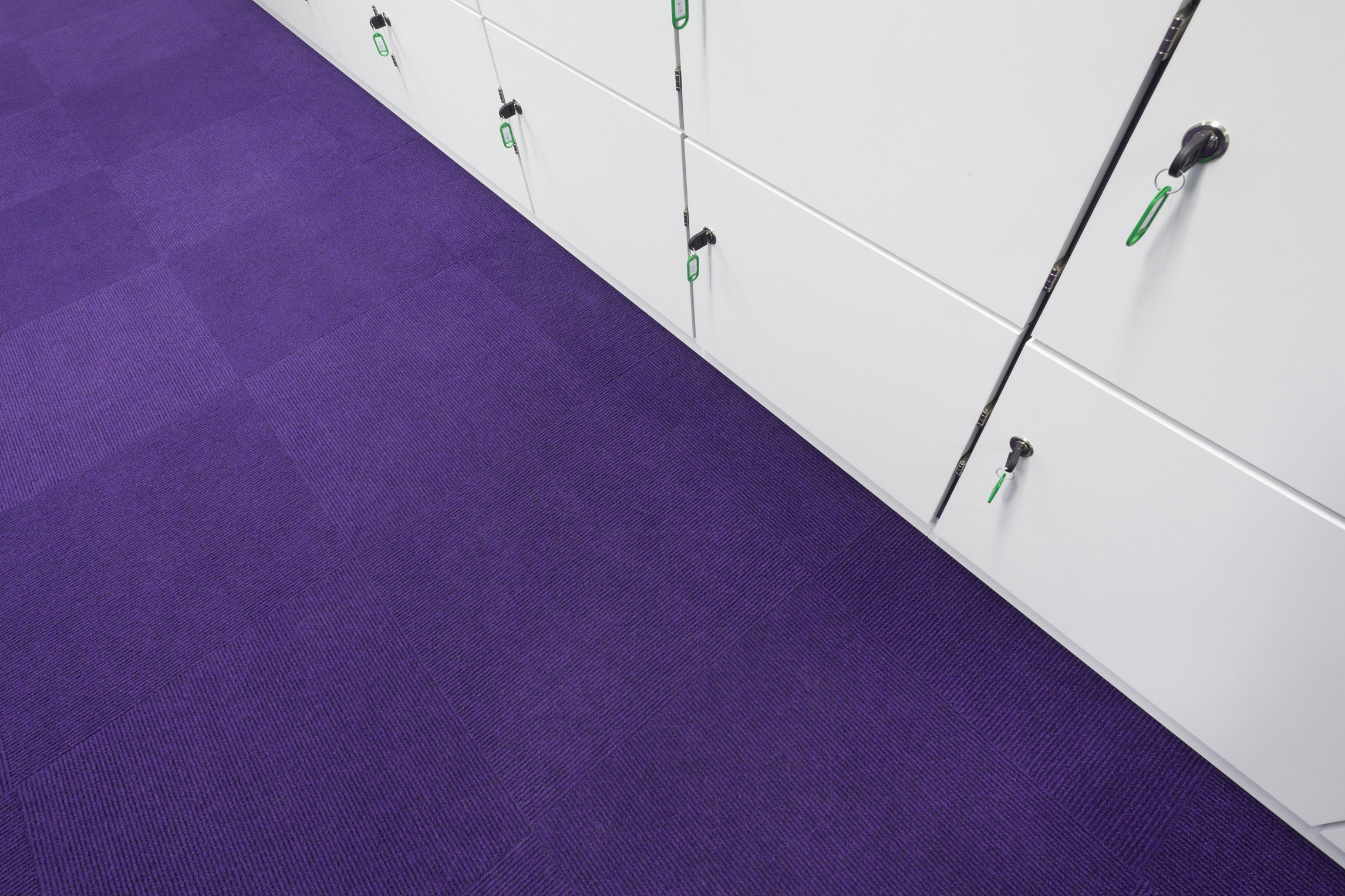 Heckmondwike Broadrib Purple Carpet Tile in locker room.