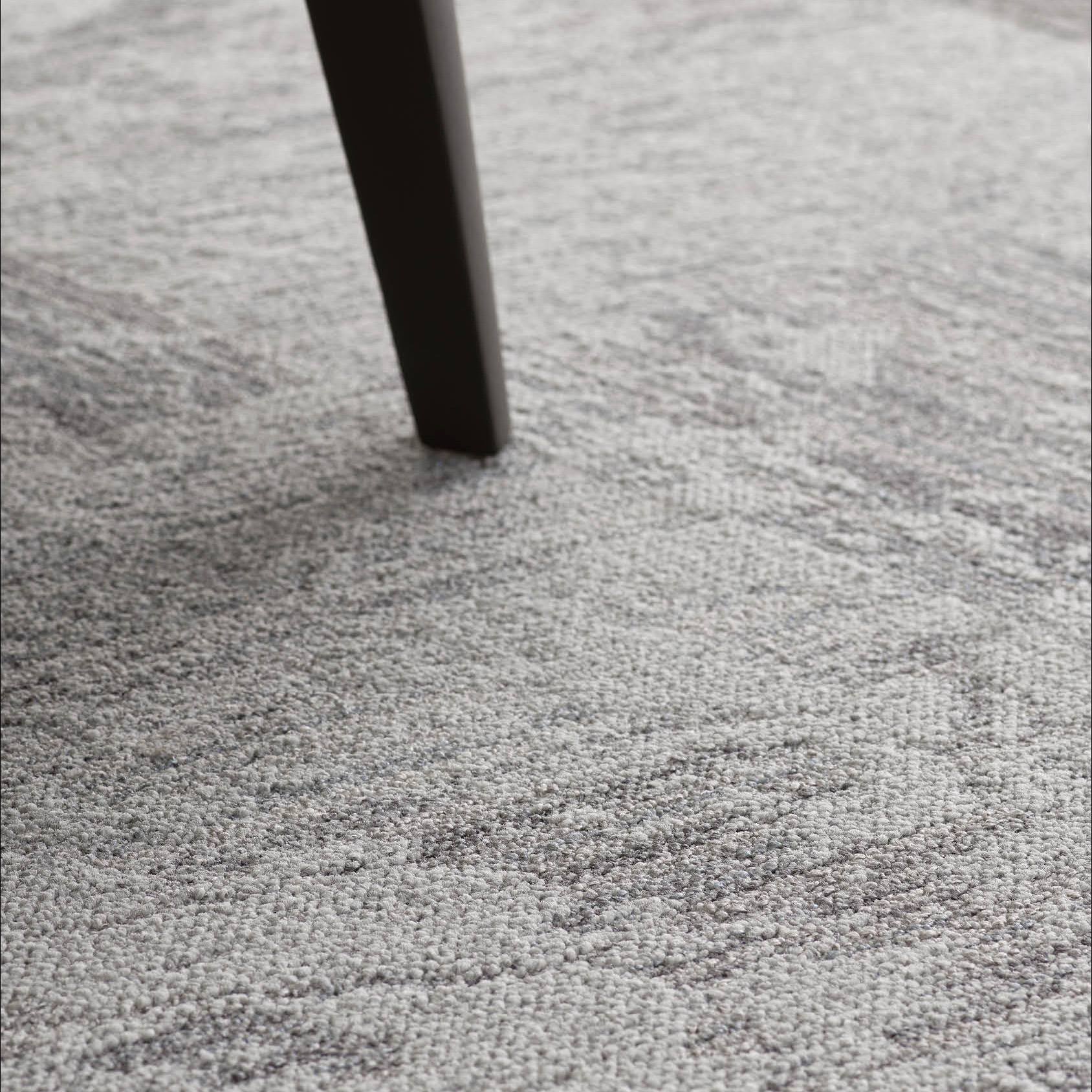 Desso Breccia Carpet Tile in a commercial office space in dark grey with table peg