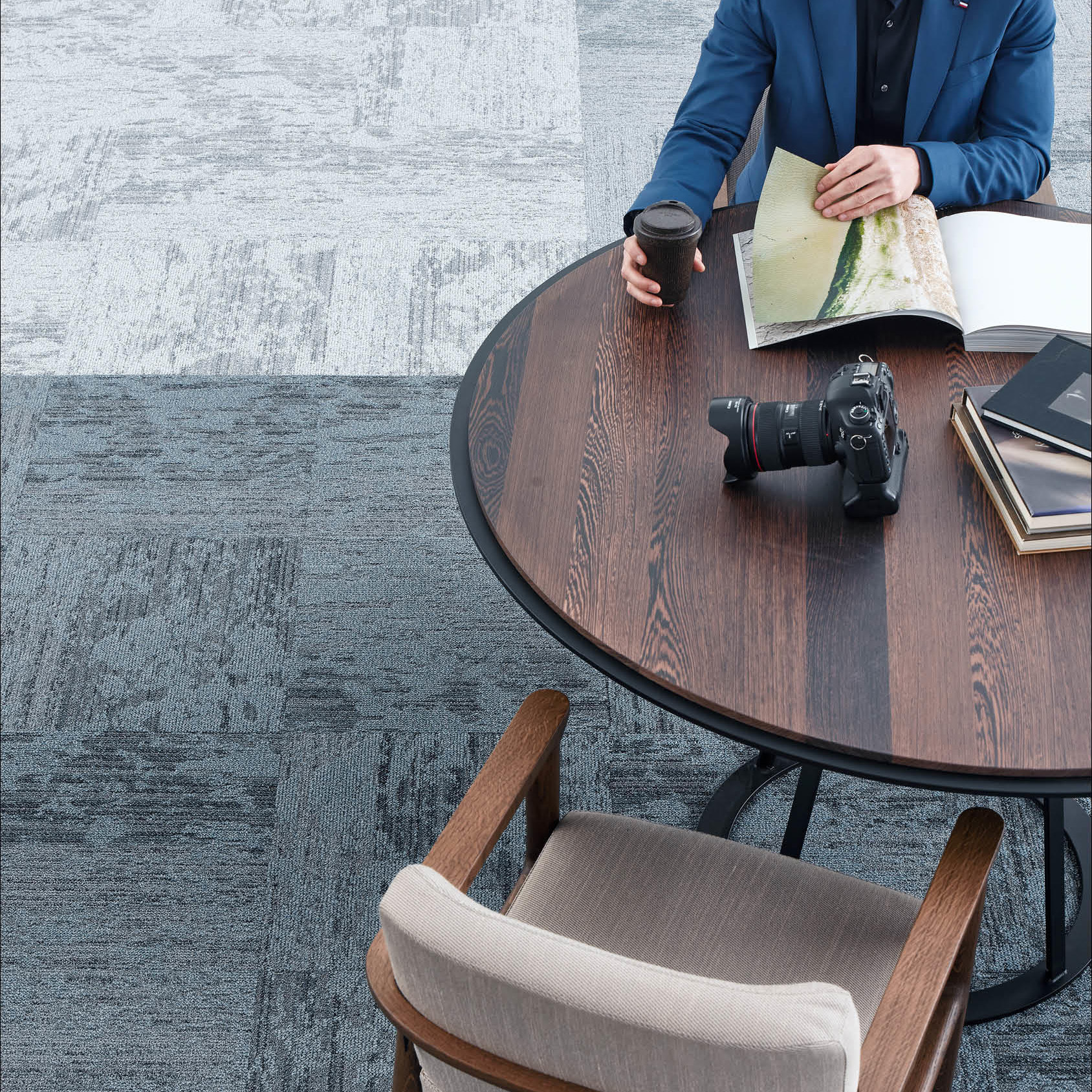 Desso Breccia Carpet Tile used for commercial office space with man reading brochure